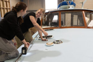 Photo of two young boat building students 